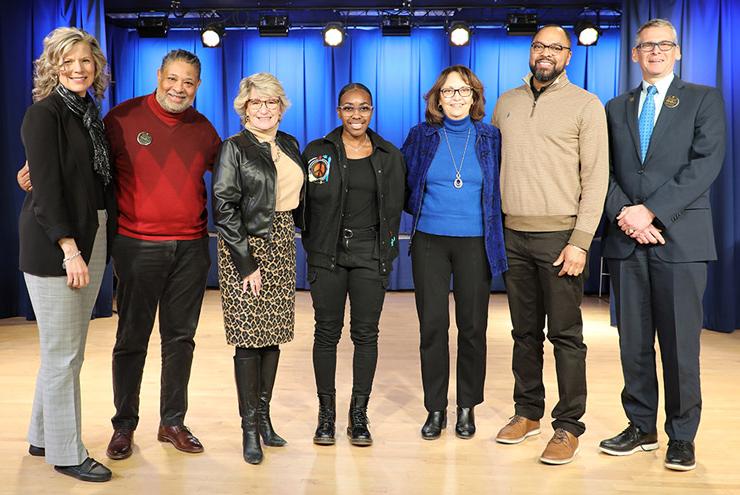 Group photo with panel members and contest winner on Kresge Hall stage